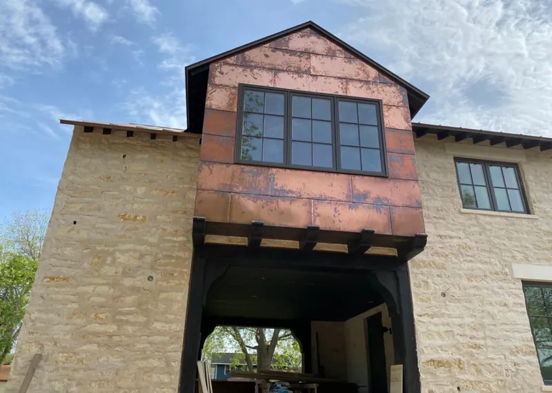 Copper metal panel facade on a stone building for Metal Roof Coating in Oxnard